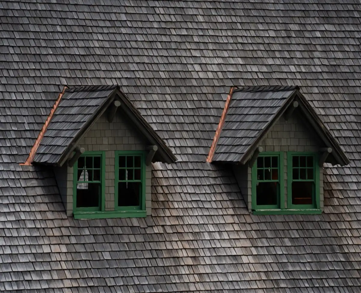 Dormers on a shingle roof in Denver, CO, where step flashing and kickout flashing carry water past the walls