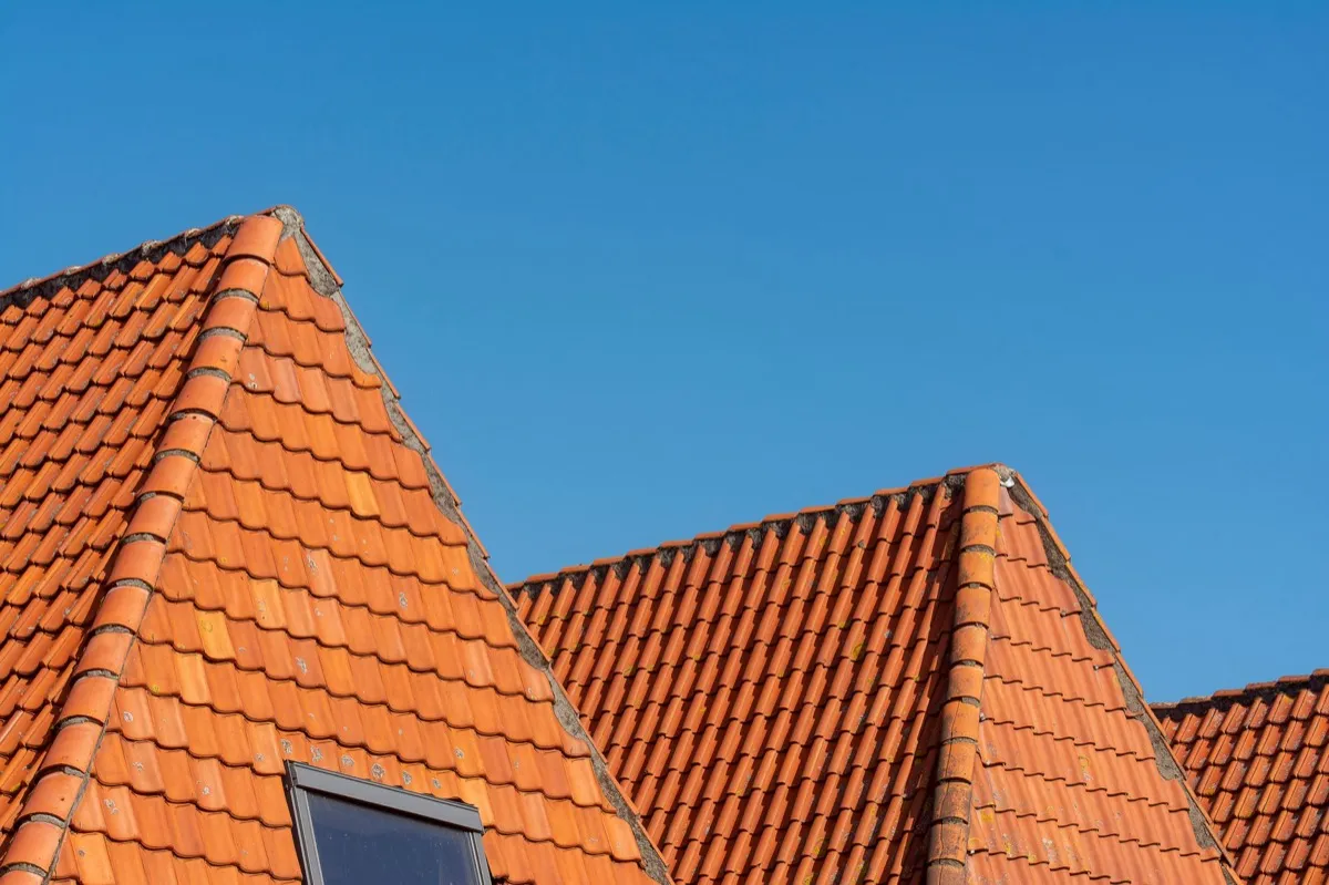 Clay barrel tile rooflines on homes in Denver, CO